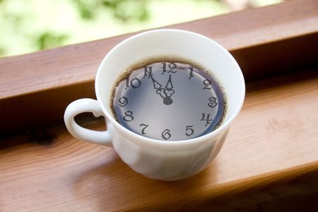 Time for a coffee break (coffee cup with the clock face in the cup of coffee)の写真素材