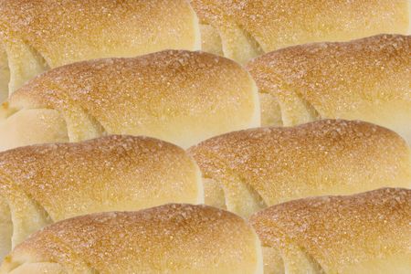 Rows of rolls with sugar (as a food background)