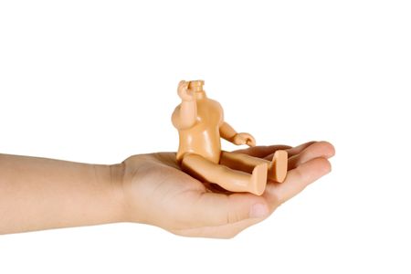 Small headless doll sitting on a childs hand (isolated on white)の写真素材