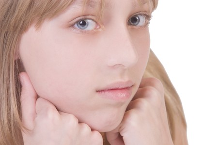 Portrait of a beautiful thoughtful blonde girl (isolated on white)の写真素材
