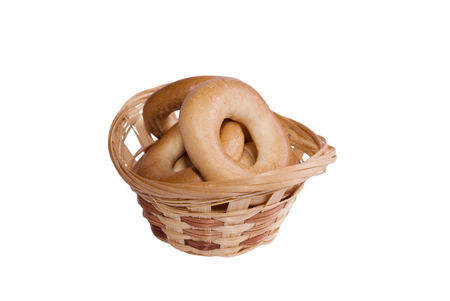 Small woven basket full of bagels isolated on whiteの写真素材