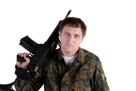 Portrait of a soldier holding a gun isolated on whiteの写真素材