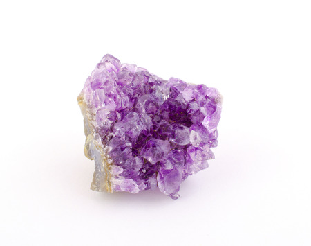 Purple amethyst stone isolated on white (as rough amethyst crystals)の写真素材