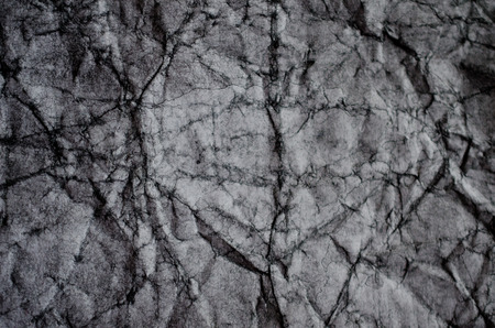 Crumpled black and white paper (as a paper background or paper texture)の写真素材