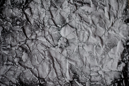 Crumpled black and white paper (as a paper background or paper texture)の写真素材