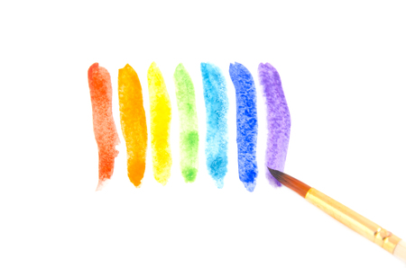 Watercolor brush strokes of rainbow colors and a brush (isolated on white)の写真素材