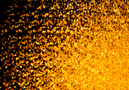 Beautiful bright golden background (as an abstract festive background), with a dark area on the leftの写真素材