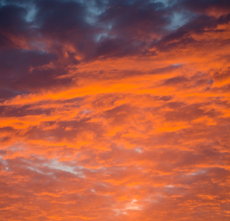 Dramatic sunset sky with bright orange clouds (as an abstract background)の写真素材