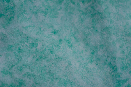 Slightly blurred crumpled green paper (as a paper background or abstract green background)の写真素材
