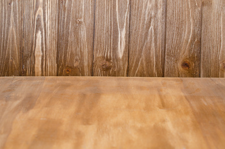 Worn wooden texture as a forefront and wooden boards as a background (selective focus on the wooden boards)の写真素材