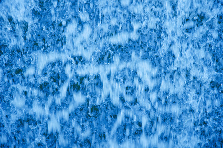 Out-of-focus bright blue flowing water as an abstract blurred water backgroundの写真素材