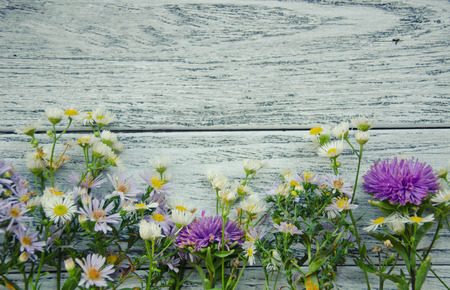 Bright autumn flowers on a gray wooden background (with copy space for your text), retro styleの写真素材