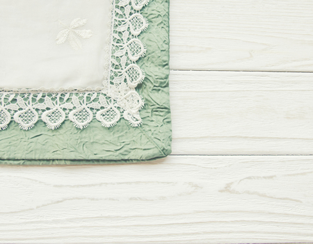 Table cover decorated with white lace (on a white wooden background), copy space on the right, retro styleの写真素材