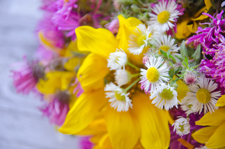 Bouquet of bright yellow and purple autumn flowers against a blurred background (selective focus)の写真素材