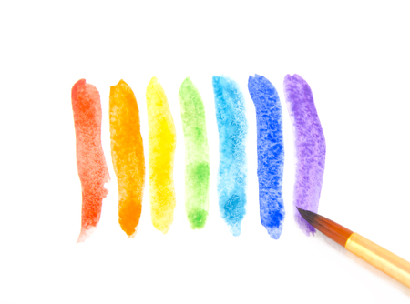 Watercolor brush strokes of rainbow colors and a brush (isolated on white)の写真素材