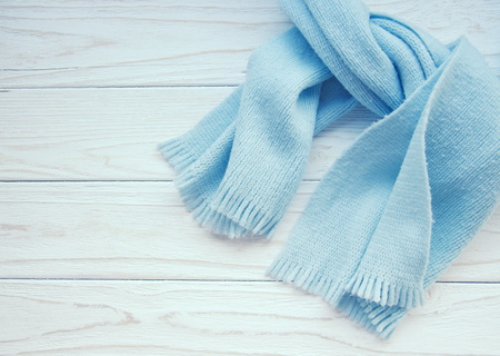 Light blue scarf tied up on a wooden background (copy space on the left), retro styleの写真素材