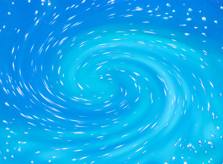 Soft focus blurred bright blue water swirl (as a beautiful abstract magic background)の写真素材