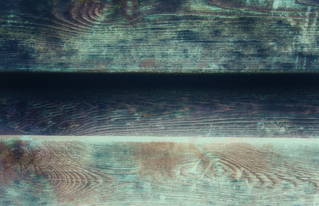 Worn wooden background (wall of an old wooden house) with a faded film effectの写真素材