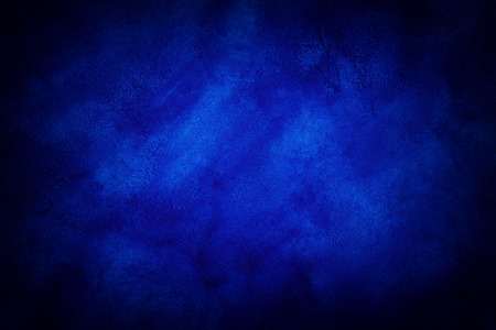 Dark blue marble or cracked concrete background with some light in the center (as an abstract mystical background or marble or concrete texture)の写真素材