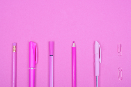 Top view of school or office supplies of a pastel pink color on a pastel pink background, copy space for your text (minimal concept)の写真素材