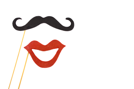 Moustache and red mouth on wooden sticks (isolated on white, copy space on the right)の写真素材