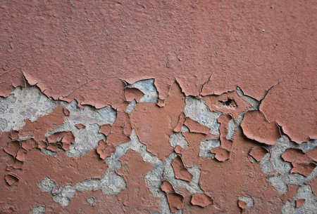 Cracked peeling plaster on the wall (as an abstract grungy background)の写真素材