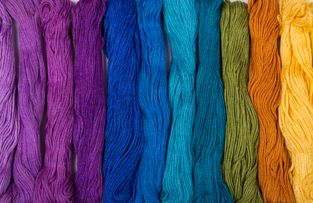Set of embroidery threads of different bright colors (as an abstract background)