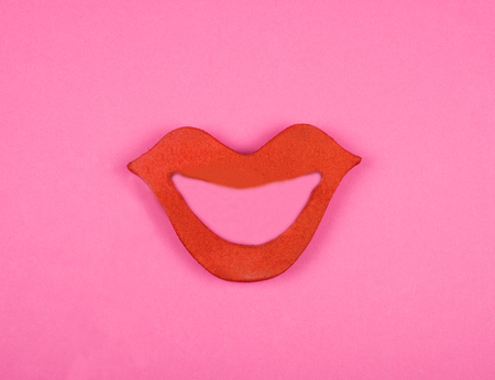 Bright red lips on a pink background (minimal concept)の写真素材
