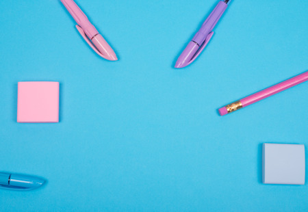 Top view of school or office supplies of pastel colors on a light blue background, copy space for your text (as back to school or business office concept)の写真素材