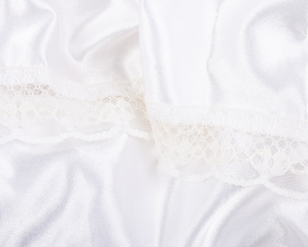 Folded white silk and lace (as an abstract background), shallow DOF, selective focusの写真素材