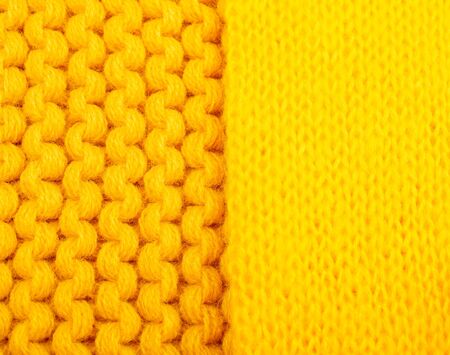 Macro shot of two different bright yellow knitted wool texturesの写真素材