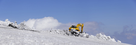 Bulldozer with shovel remove snow. Mount Etna, Sicily.の写真素材