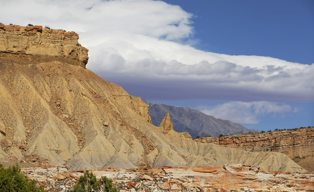 Capitol reef, central Utah, USA. Panoramic view to valley and mountains with beautiful clouds in blue sky. Colorful rocks and clays in geological formation.の写真素材