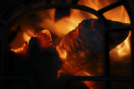 Firewood burning in old iron oven. Close up.の写真素材