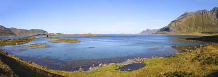 panoramic view from fredvang bridges to ramberg in autumn with mountains in backgrond and beautiful blue fjord in foreground , lofoten islands, norwayの写真素材