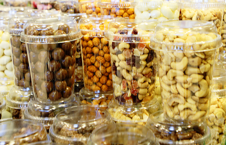 Dried fruit and nuts in plastic containers, blured for bacjground.の写真素材