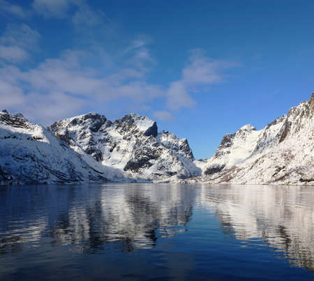 Beautiful reflection of winter mountains in Olenilsoya in Reine, Lofoten Islands, Norwayの写真素材
