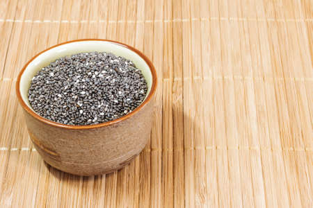 Chia seeds-ceramic bowl on a wooden background. Healthy diet. Healthy lifestyle.の写真素材