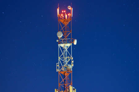 GSM 5G,4G,3G tower. The antenna of a cell phone on the background of the starry sky.の写真素材