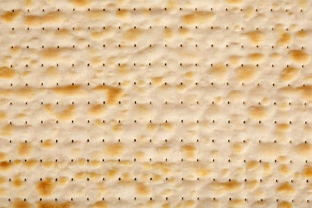 Jewish Passover matzo close-up, browned, crispy crust close-up. It can be used as a background...