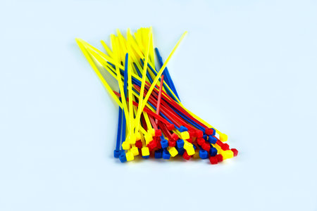 Multicolored cable clamps on a white background in the center of the screenの写真素材