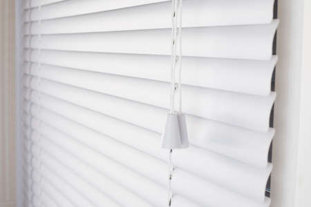 White blinds on the window with white plasticの写真素材