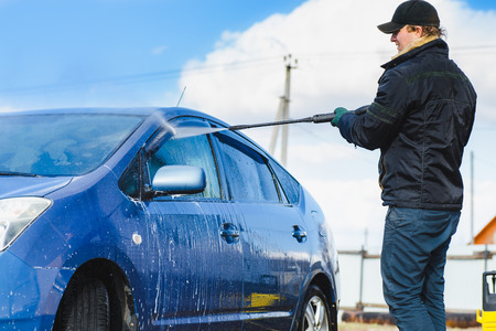 Man wasing a car using compression waterの写真素材