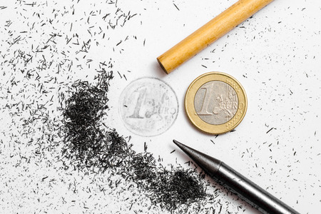 One Euro coin drawing and pencil on white backgroundの写真素材
