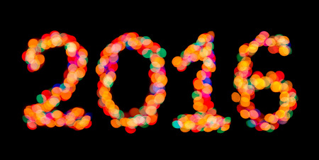 Happy New Year 2016 colorful symbol. Bokeh photography the luminous numerals on a black background.