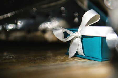 Small gift box blue, turquoise, green, mint green with a bow of satin ribbon is a wooden vintage...