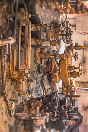 Golden and black control valves of an old steam engine in Asukayama Park in the Kita District of Tokyo, Japan.のeditorial素材