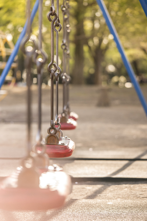 Red swing in the kindergarten of Asukayama park in the Kita district of Tokyo, Japan.の写真素材