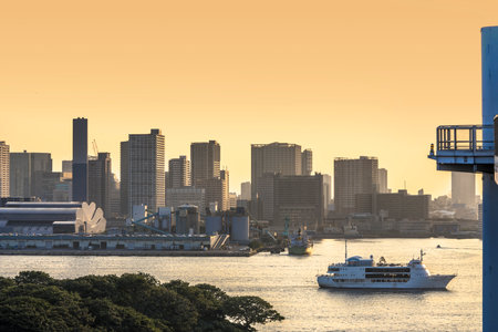 'Vingt et Un' 'Twenty-one' cruise ship sailing in Odaiba Bay between Daiba Park and Rainbow Bridge at sunset.のeditorial素材