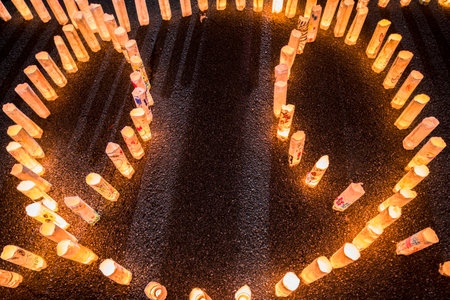Handmade japanese washi paper lanterns aligned in circles illuminating the stone steps of the Zojoji...